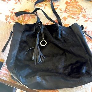 Black purse leather front has like cow hair